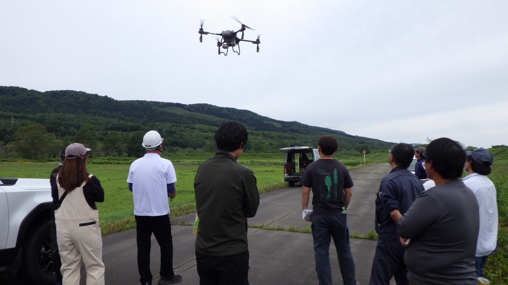 設定を終えて空中散布に向かうドローン